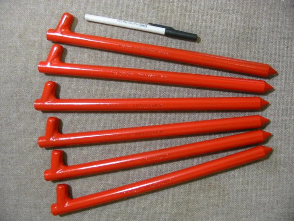 A six pack of 12" long Orange metal tent pegs, tent anchors or stakes